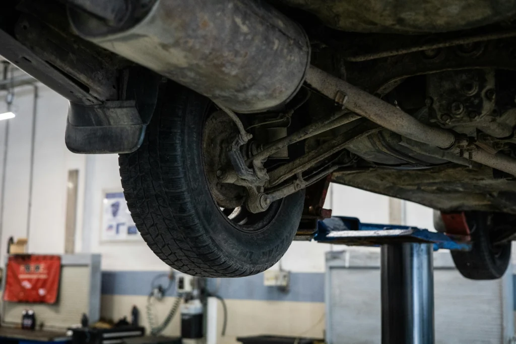 Underneath view of a car that has been raised in the air