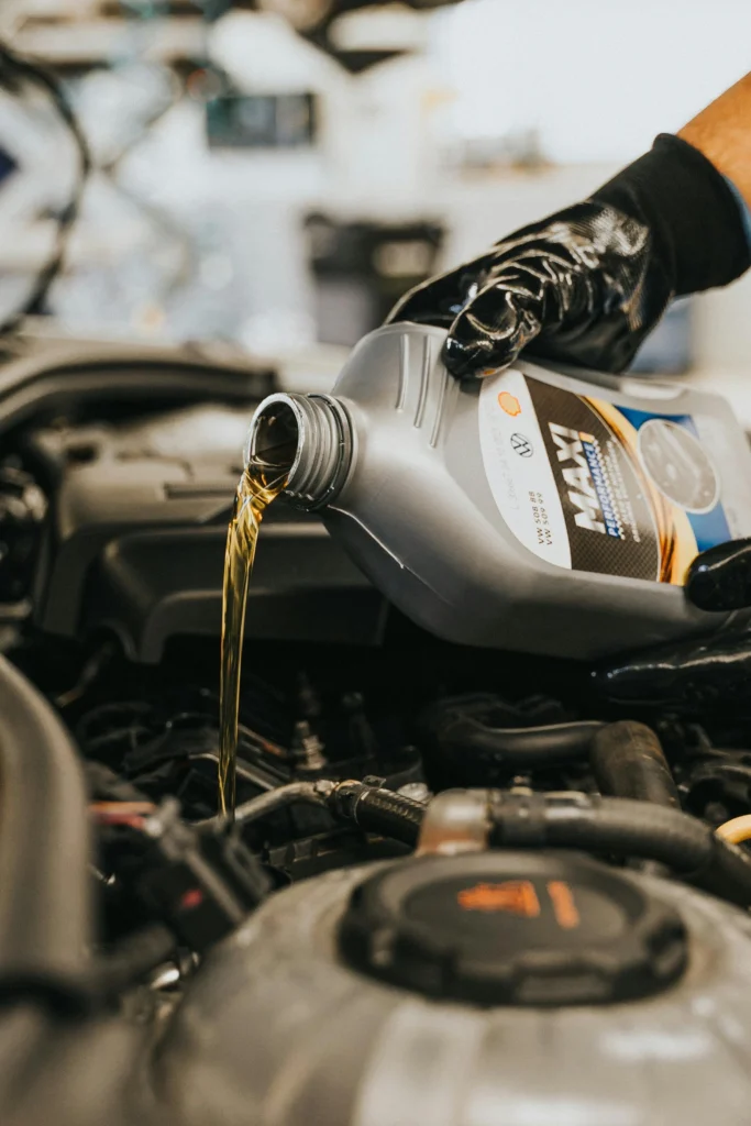 Close-up of someone pouring engine oil into the car