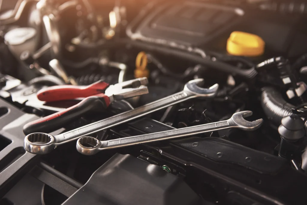 mechanic-hand-checking-fixing-broken-car-car-service-garage – eurotyrescoalville.co.uk Close up view of a car engine with tools on top